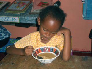 children-eating-jeffrey-town-jamaica